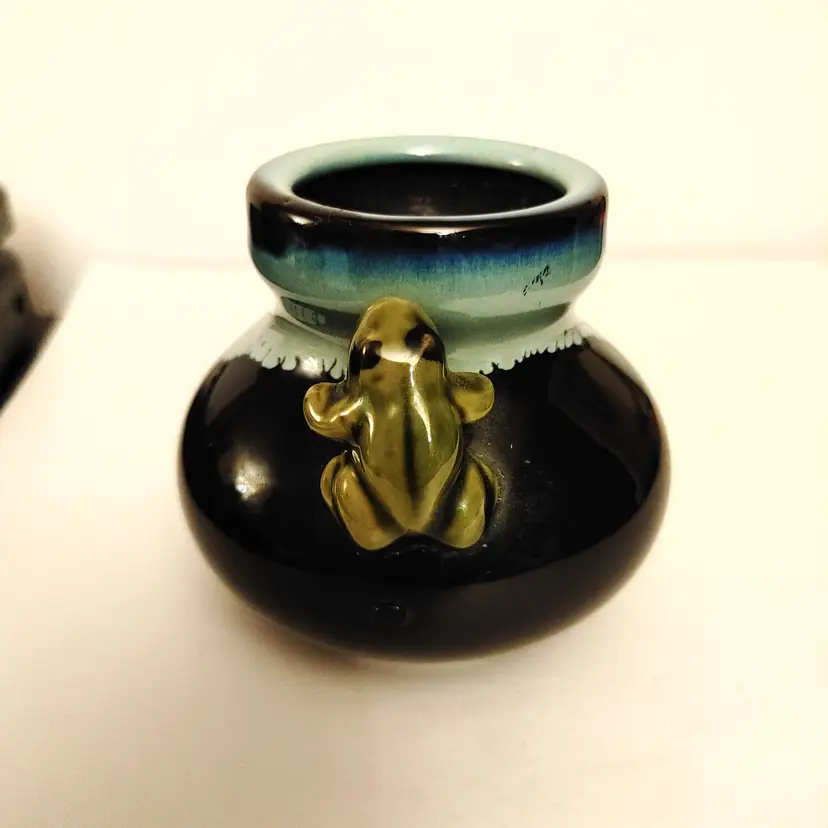 Majolica-style ceramic planter/vase with a green frog figure in a blue & black drip glaze. 3.5 inches high. No condition issues.