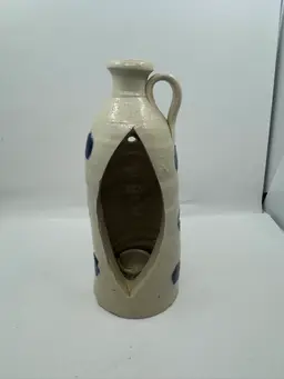 Speckled stoneware jug with cobalt blue dots and cutout candle holder