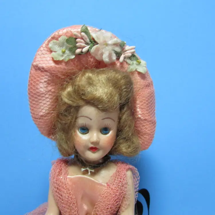 vintage plastic doll in pink gown and hat, sleepy eyes blonde hair 7" girl