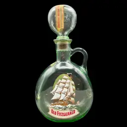 #243B Vintage ‘1849 Flagship’ Green Glass Decanter for Old Fitzgerald Whiskey. This Bottle was Released in the 1960’s to Commemorate the USS Constitution Which Is Depicted On The Front Of The Bottle. The Whiskey was Produced by the Stitzel-Weller Distillery