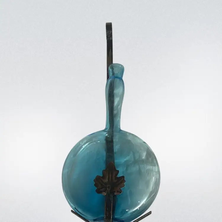 Blue Glass Bottle In Metal Holder