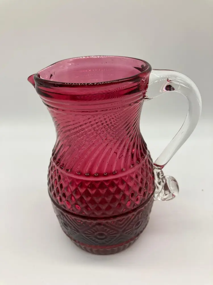 Vintage Pilgrim MCM cranberry hand blown glass pitcher waffle, swirl and vertical cut pattern, with clear pulled handle.