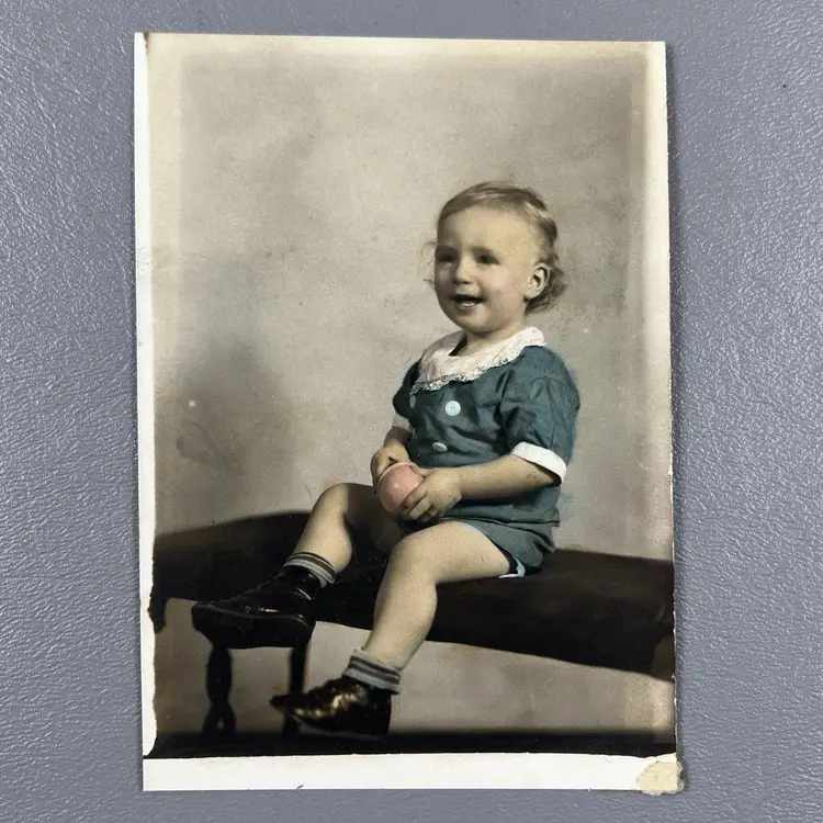 Vintage Early 1900s Studio Portrait Photo Child Sitting On A Bench With Toy Color-Tinted Blue
