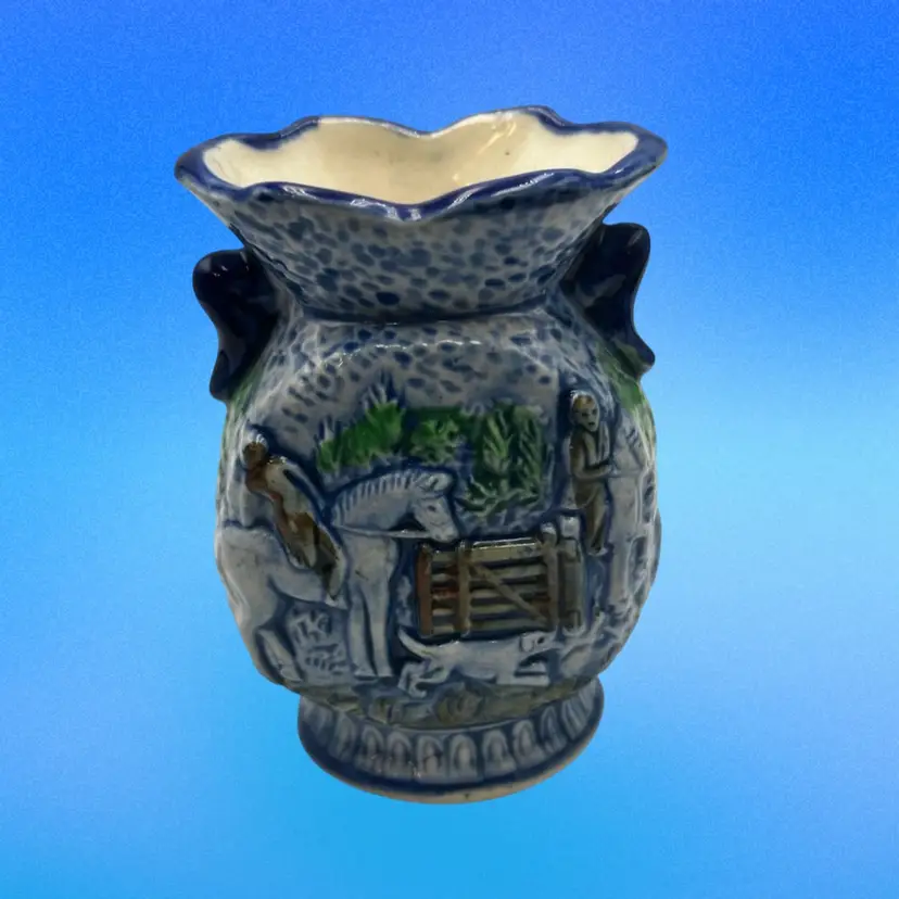 A14 A vintage Japanese porcelain vase with a raised hunting scene.