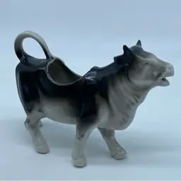 #5004 Vintage German porcelain cow creamer, model number 8971, with a black and white glaze.