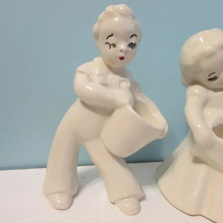 vintage off white couple planter holder man and woman holding bucket basket