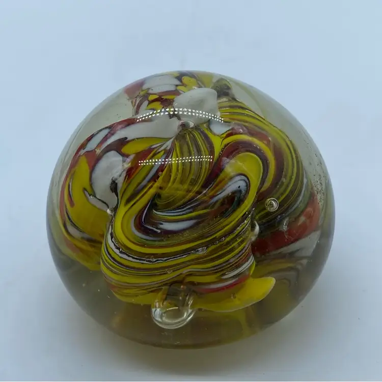 #0051 Vintage art glass paperweight with red, yellow, and white swirls.