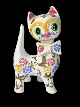 Charming Mid-Century Modern ceramic cat figurine featuring vibrant hand-painted florals and a cute bow tie.