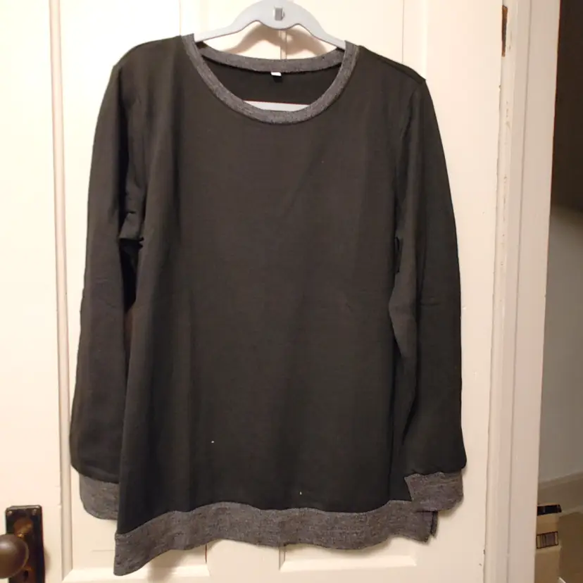 Top- Brand: Unknown. Size Large. Black top with grey trim. Material- 65% polyester, 35% rayon. No callouts.