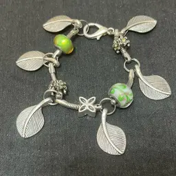 Unique Silvertone Leaf Charm Bracelet With Green Accents