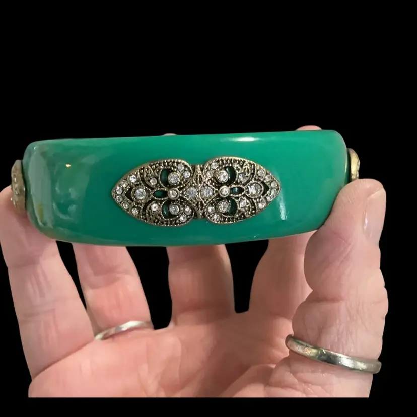 Vintage 1990s Retired Premier Design Emerald Green Lucite Bangle. With Ornate Filigree Design& Inset With Clear Glass Rhinestones. From The “ Roaring Chic” Collection.