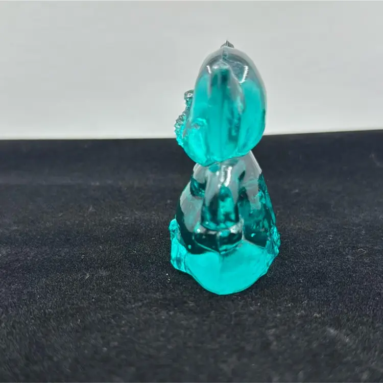 Teal Glass Elephant Sitting With Hands On Hips