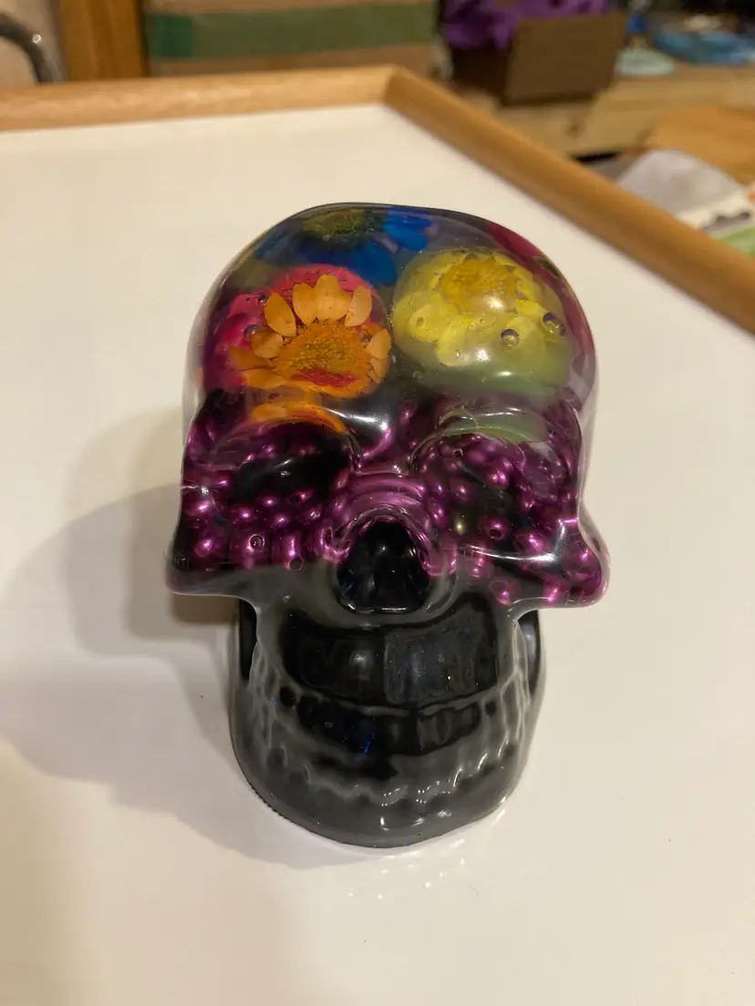 Floral and bead resin skull figure paperweight