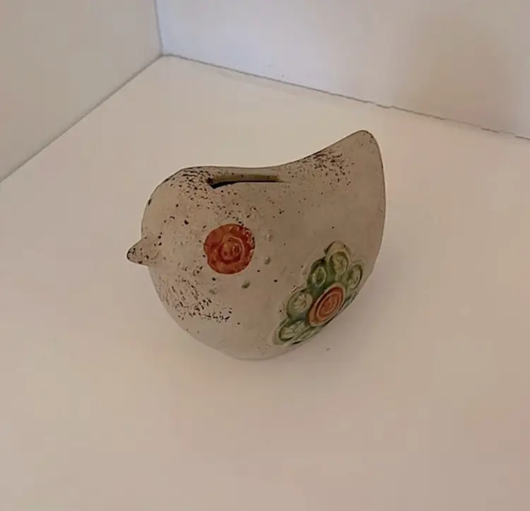 Sweet pottery bird bank with hand painted/glazed rust eyes and green wings!