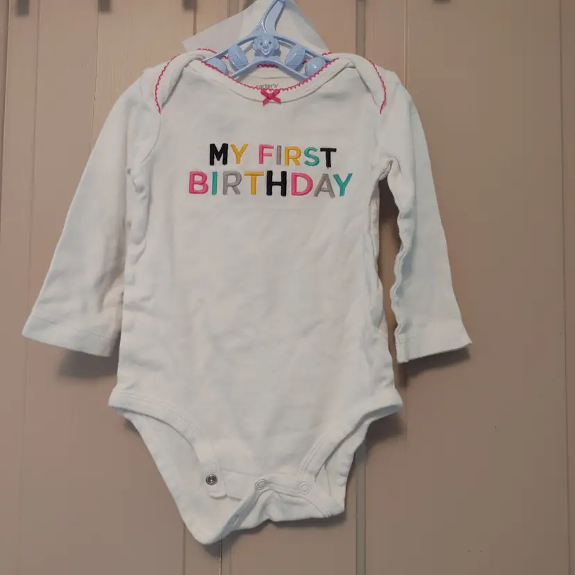 Kids- Brand: Carters. Size 12 months. My First Birthday onesie. Material- 100% cotton. No callouts.