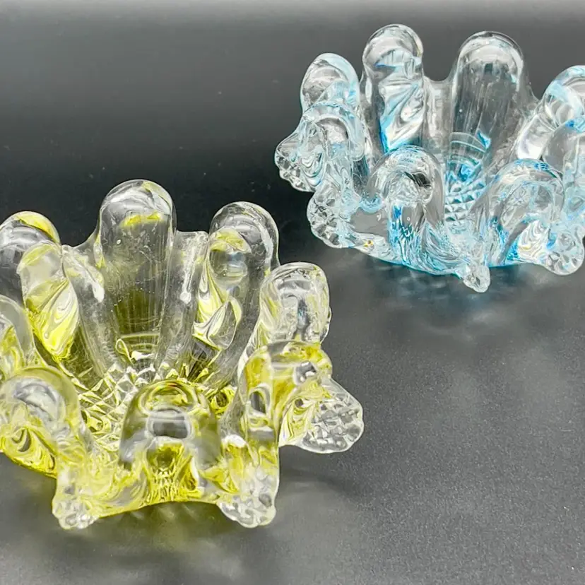 Art glass votive holders.  One blue, one yellow.  Stackable