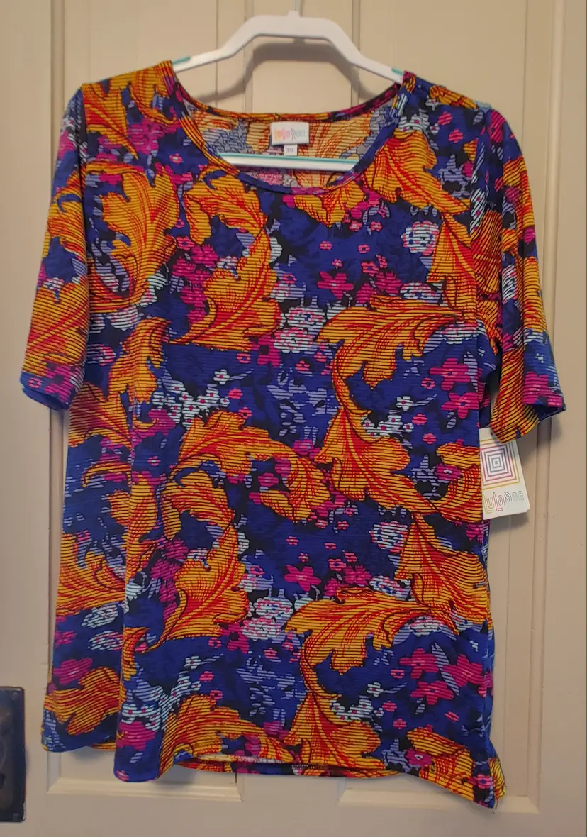 Top- Brand: LuLaRoe. Size 3X. NWT. Bright floral top. Material- 96% polyester, 4% spandex. No callouts.