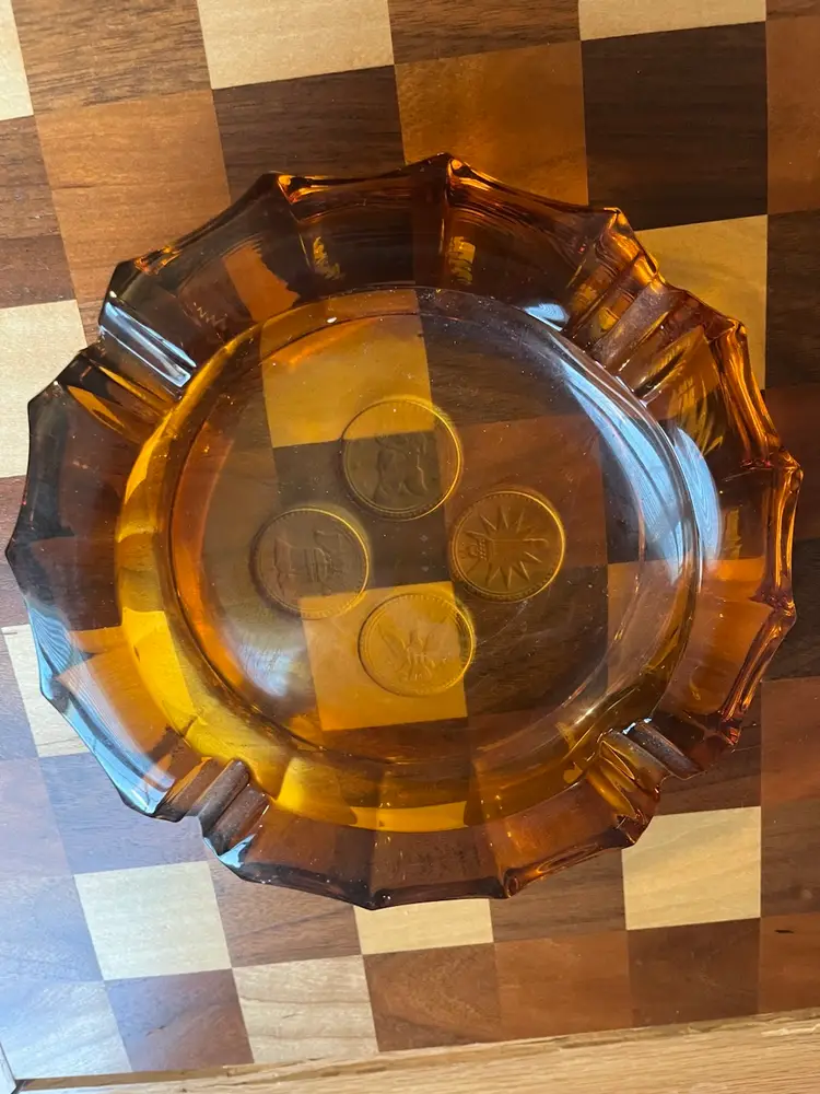 Amber Fostoria Coin Glass Ashtray with embedded coin designs. 8”