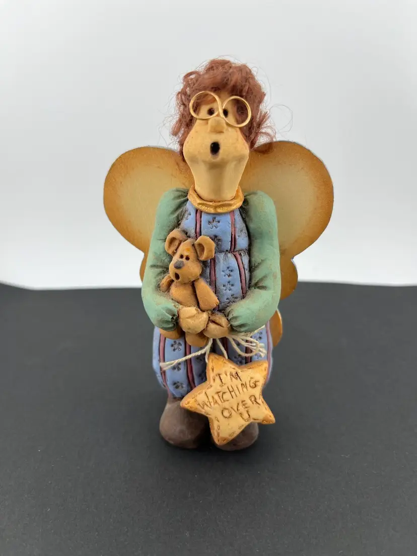 Diana Zufall-Designs by Diana. "I'm watching over U". Cutest angel with ginger hair, holding teddy bear and a heart with inscription.