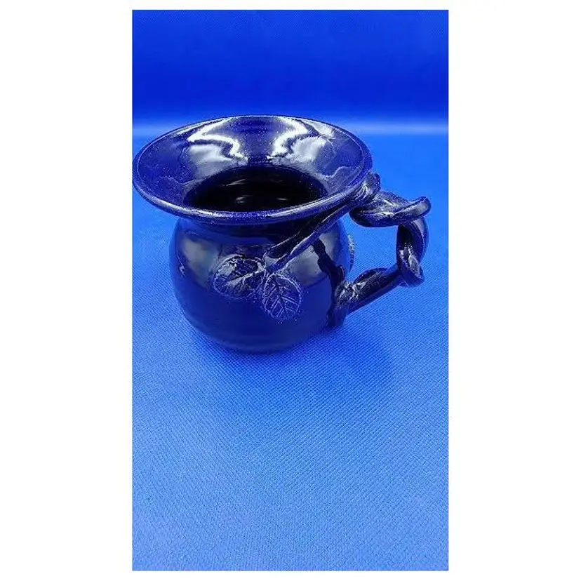 SIGNED BLUE MUG WITH 3D VINES AROUND HANDLE