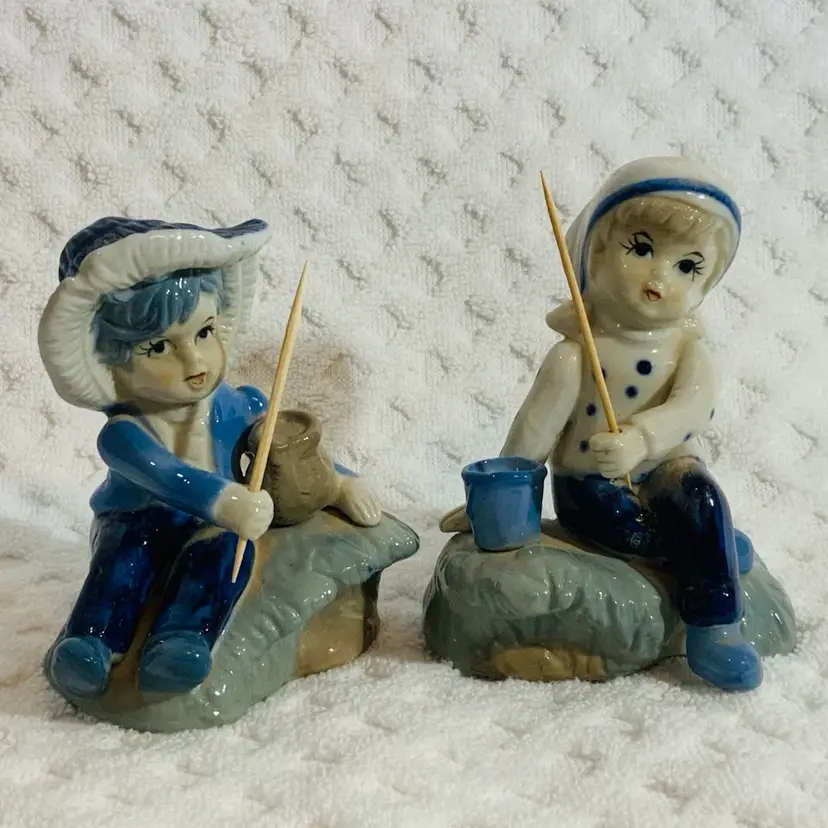 Vintage 2 Figurines Boy and Girl Wearing Blue White Both Girl and Boy Riding Or Sitting On Wave Fishing