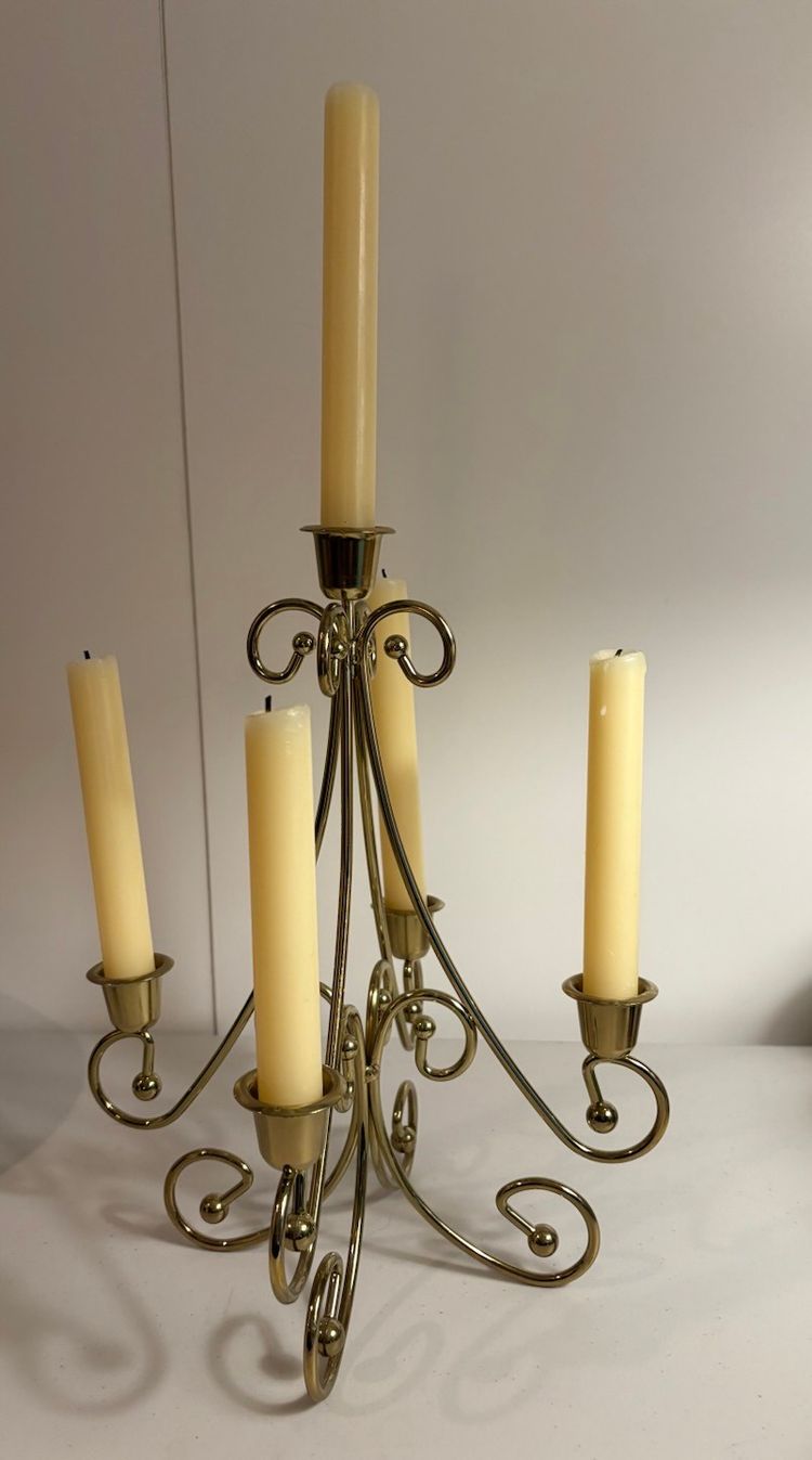 Vintage gold metal candelabra with a scrollwork design and five candle cups
