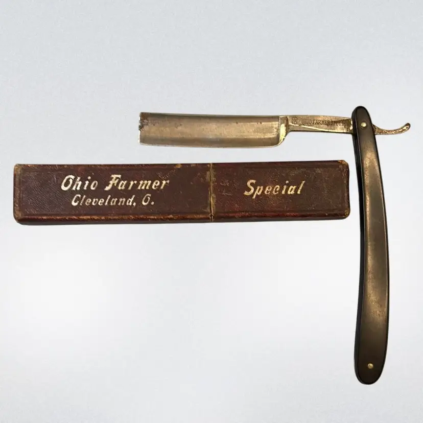 Vintage Ohio Farmer Special straight razor presented in its original Box. The box indicates it was associated with "Ohio Farmer" in Cleveland, Ohio And The Blade Is Marked old Farmer Special. There Is A 89 Engraved Also. Maybe The Year?
Condition: Appears complete, with a black handle and steel blade, likely dating from the late 19th to early 20th century based on similar antique shaving Tools. Blade States Made In Germany.