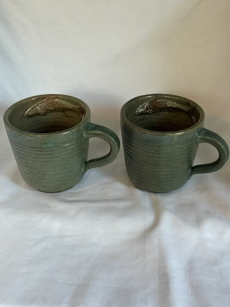 Set Of Two Pottery Mugs Made In Cameroon W/Embossed Fish Design On The Mug Interior.  Marked.