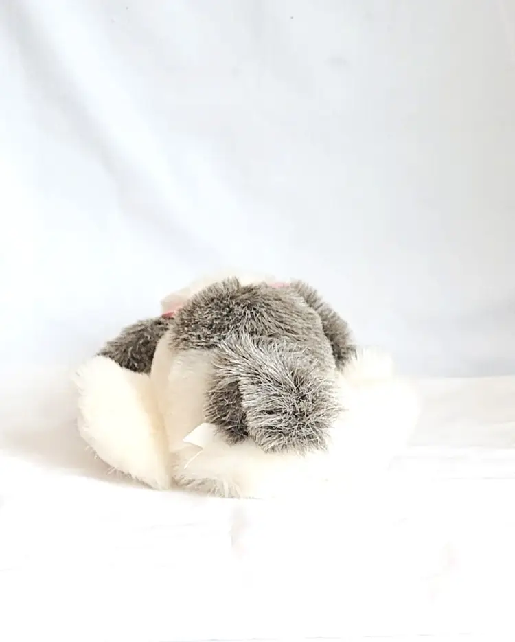 Reclining Gray and White Stuffed Toy Dog