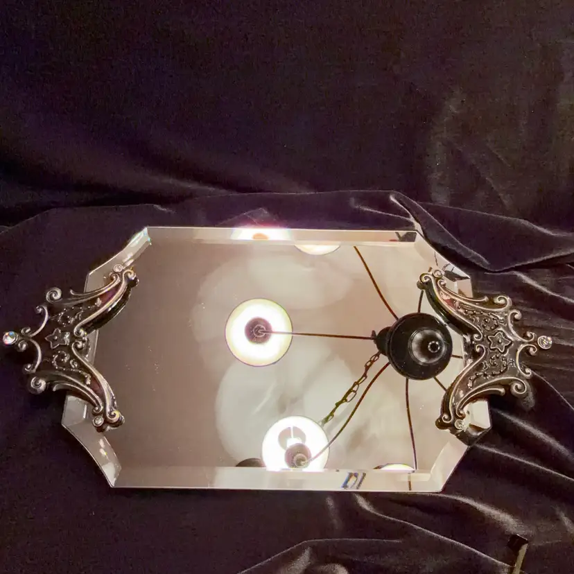 Vintage decorative vanity mirror with ornate metalwork and beveled glass. ~13” x 6.5”