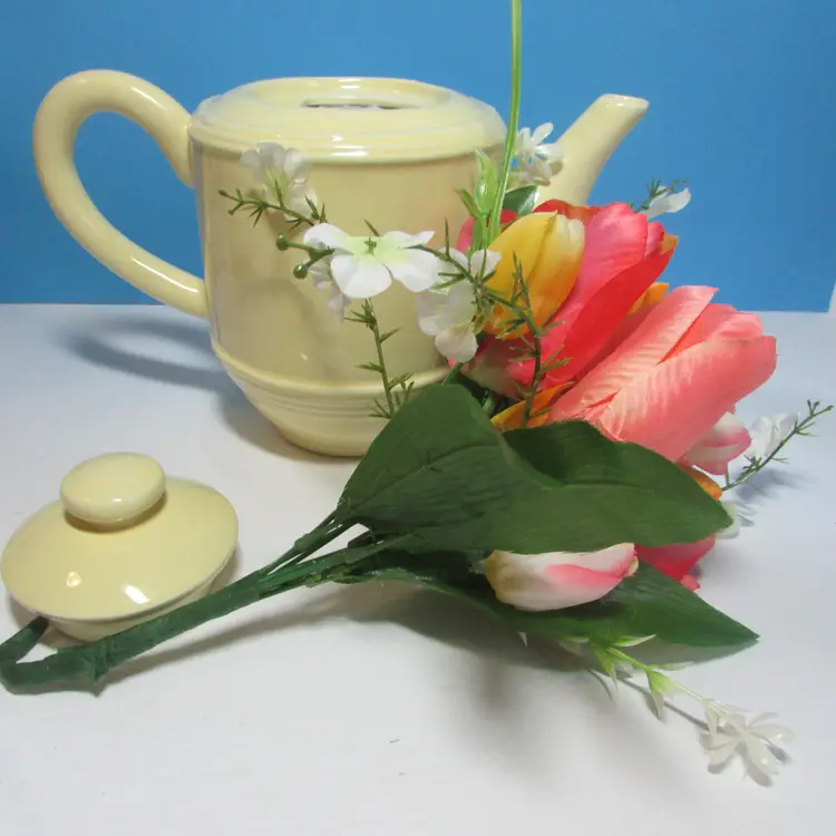 vintage pale yellow Cracker Barrel ceramic teapot with tulip flower arrangement