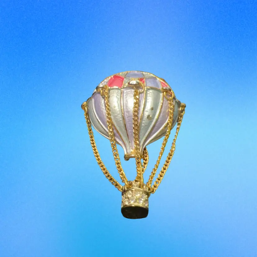 vintage hot air balloon brooch from the Museum of Fine Arts (Boston), featuring colorful enamel stripes and a movable gold-plated basket dangling from chains