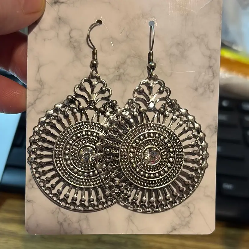 Silvertone Bohemian Style Earring With A Clear Rhinestone In The Middle Surrounded By Filigree