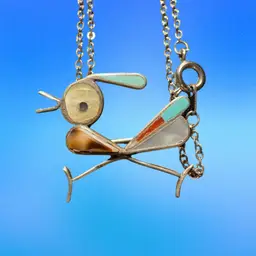 A Zuni inlaid roadrunner pendant on a silver chain.