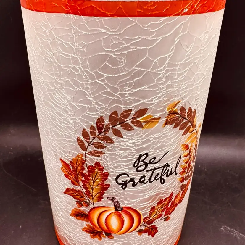 82. "Be Grateful" crackle glass vase with a pumpkin motif.