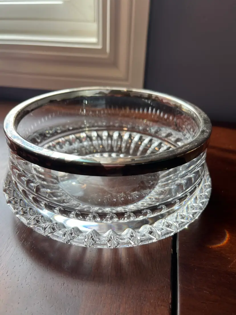 A Gorham Lyric pattern cut crystal serving bowl with a silver rim. 3H x5.5” W