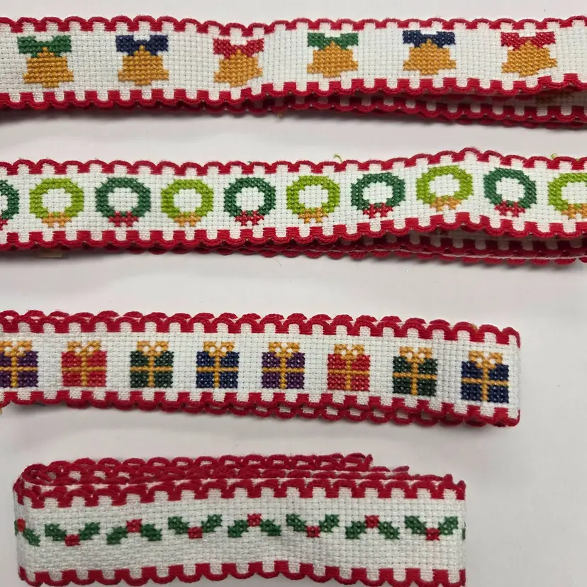 Lot of four Cross-stitched Ribband Pieces Christmas themed  Holly, present, bells and wreaths to add to crafts or wrap around gifts.