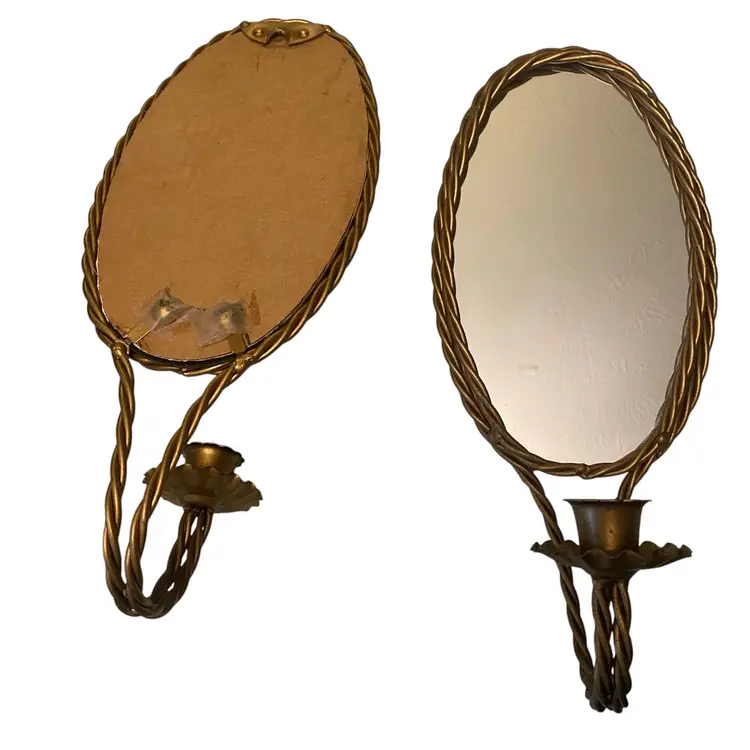 These vintage Hollywood Regency gold twisted rope mirror candle holders were likely produced by manufacturers like Homco or designed in the Italian gilt tole style during the 1960s or 1970s