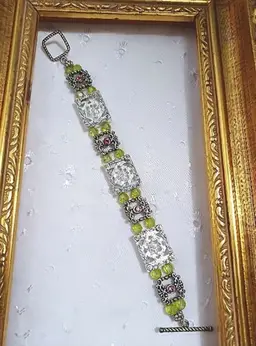 A silvertone picture frame bracelet with large toggle clasp
