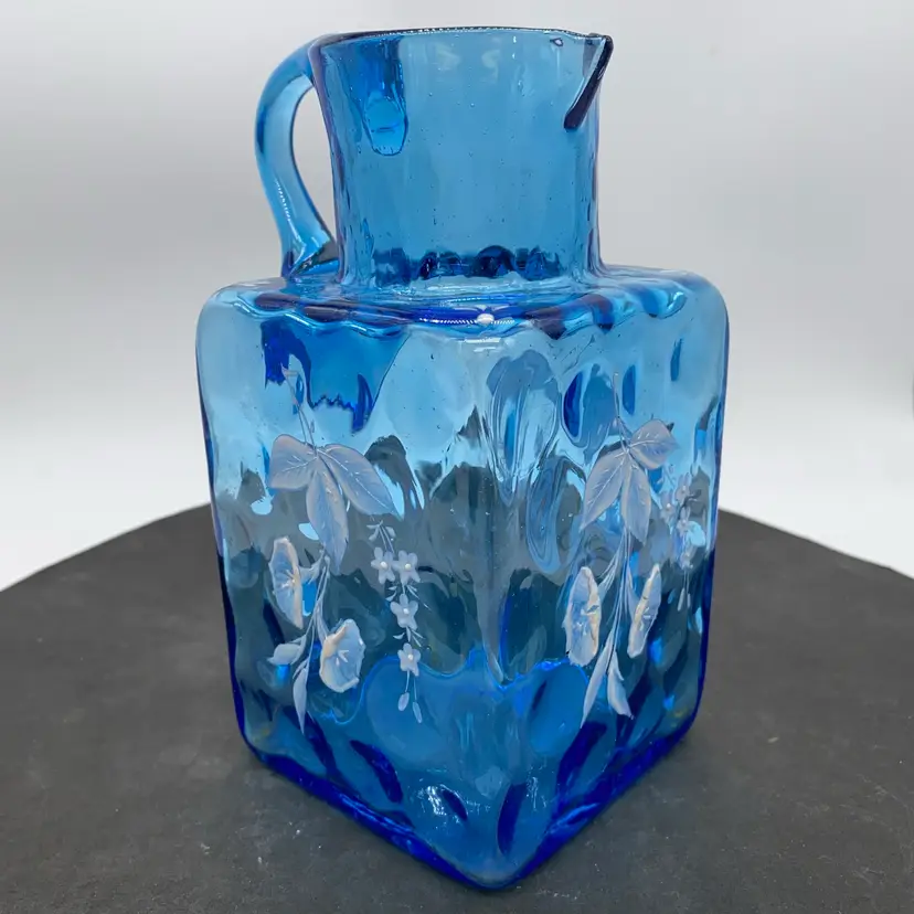 #0209 Victorian blue enameled glass pitcher with floral motifs.