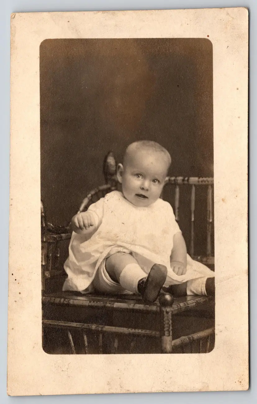 Postcard RPPC Open Mouthed Baby in White Dress Sitting in Chair Real Photo - 8753