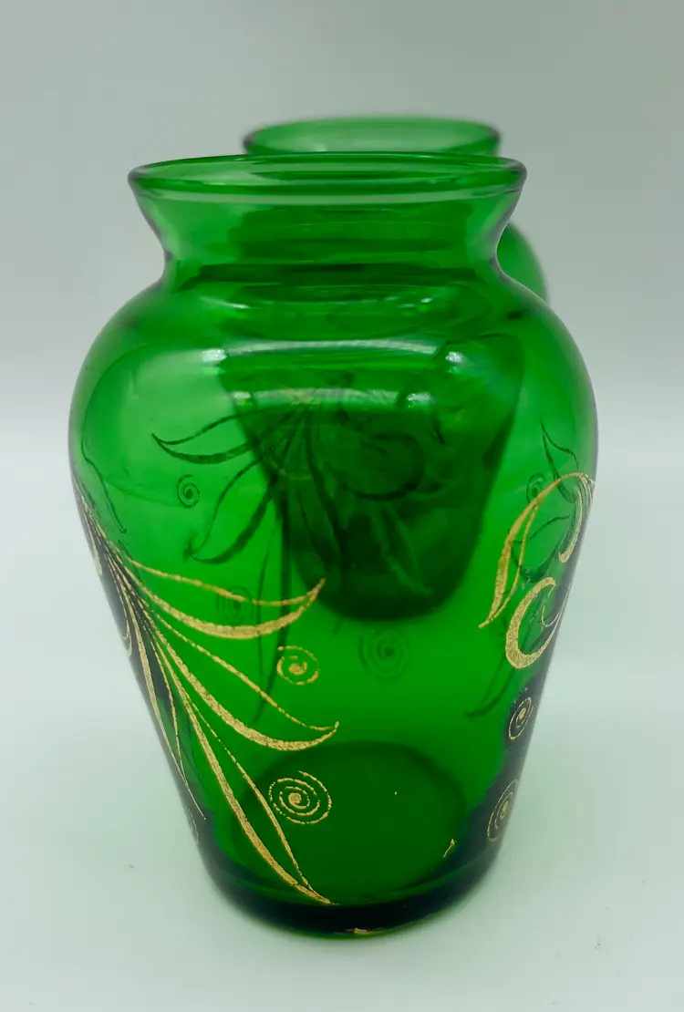 Vintage pair of emerald green Anchor Hocking glass bud vases with hand-painted gold design.