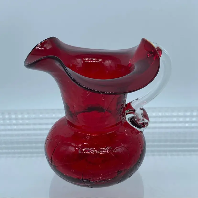 #1003 Hand-blown ruby red crackle glass mini pitcher with clear applied handle By Pilgrim