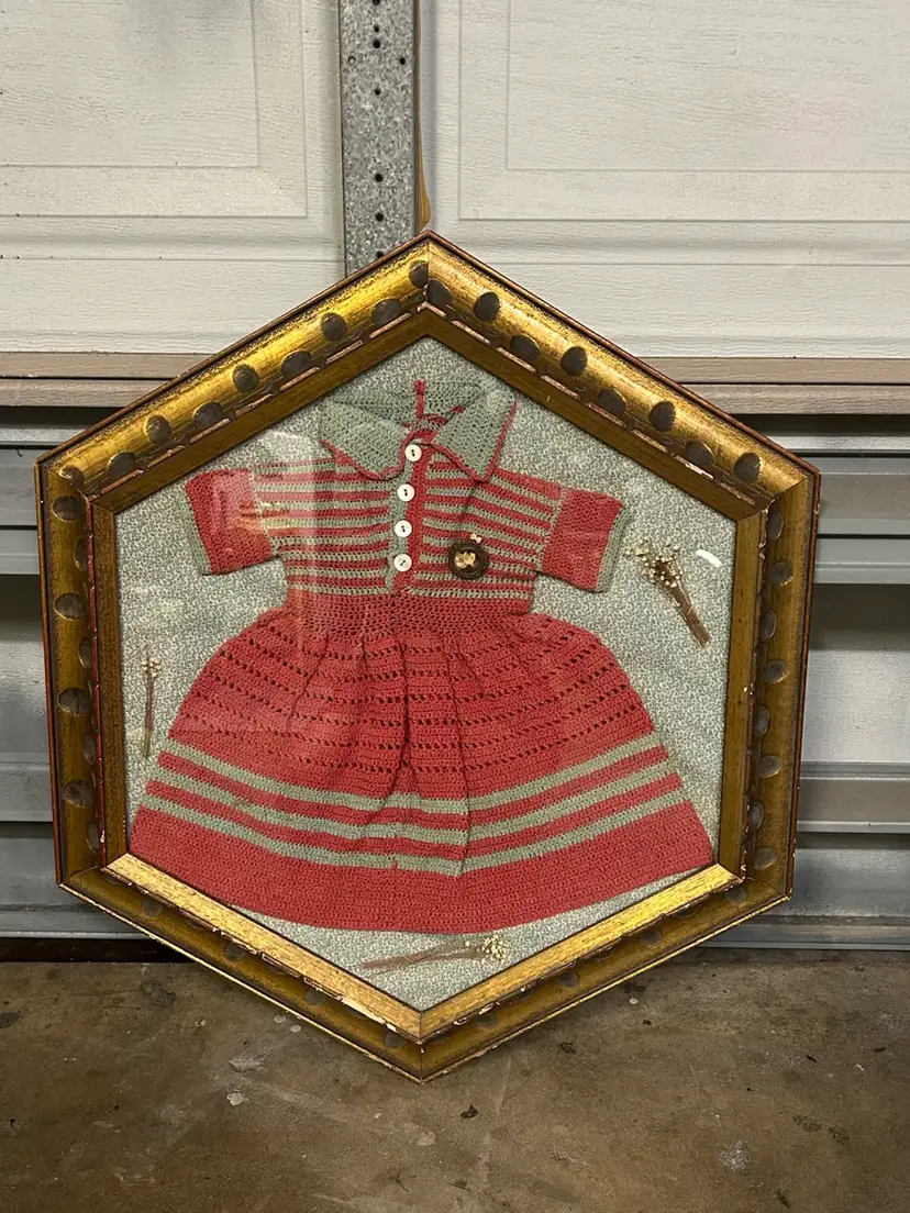 Vintage Gold hexagon shadowbox frame With striped crocheted baby dress With Old Brooch Pin