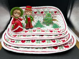 Vignette #4 Includes A Set Of 2 Vintage Ardco Victorian Christmas Boy and Girl Figurines XC-1077, 4 Oval Quilted Placemats With Reindeer, Hearts And Christmas Tree Design And A Handmade By Me Acrylic Pour Painted Tree Shaped Wood Ornament With Glitter And Resin Sealed
