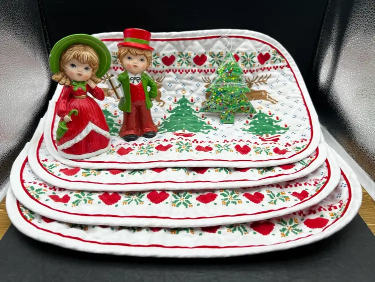 Vignette #4 Includes A Set Of 2 Vintage Ardco Victorian Christmas Boy and Girl Figurines XC-1077, 4 Oval Quilted Placemats With Reindeer, Hearts And Christmas Tree Design And A Handmade By Me Acrylic Pour Painted Tree Shaped Wood Ornament With Glitter And Resin Sealed