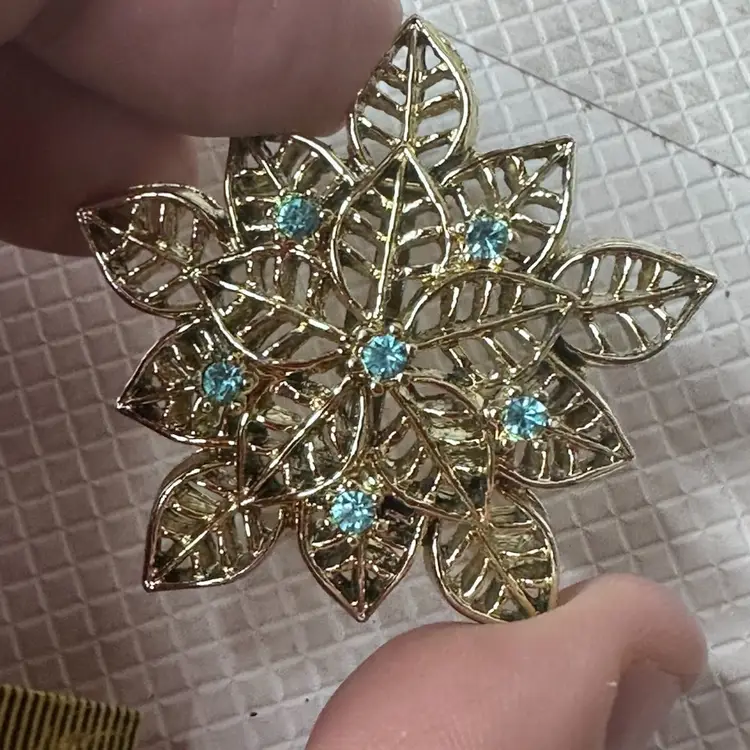 Blue Rhinestones In A Flower Brooch