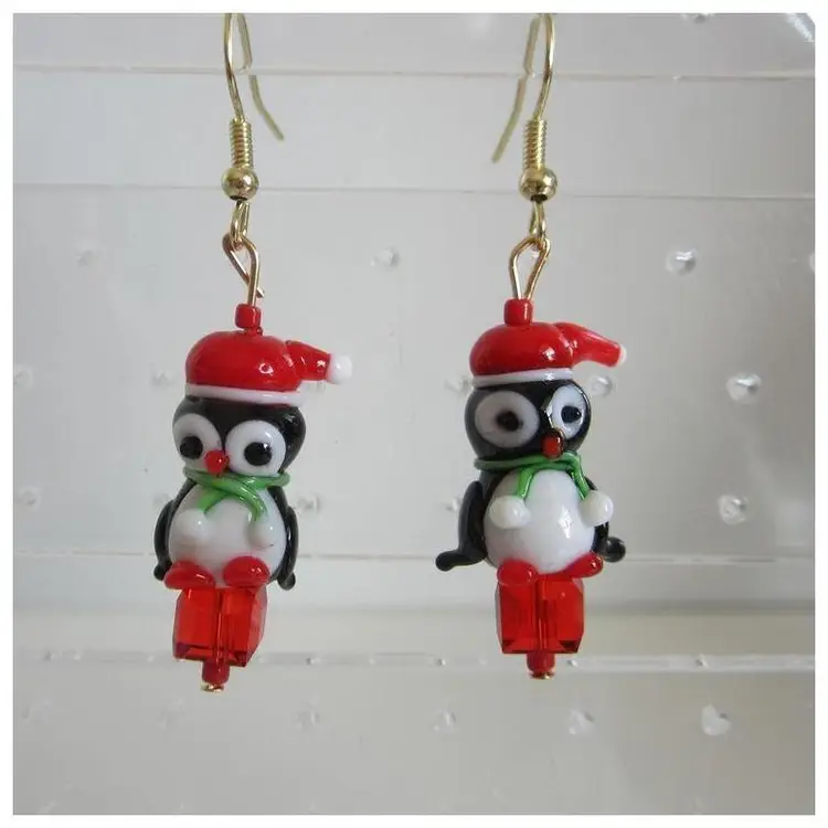Handcrafted Lampwork glass Christmas Penguins sitting on red present earrings