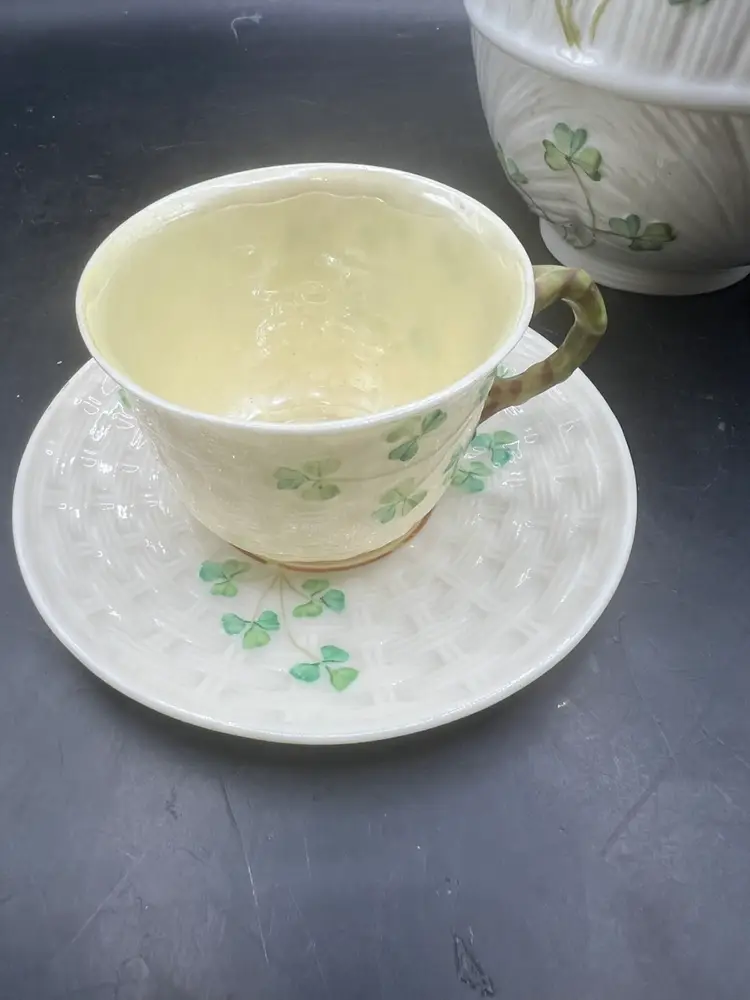 Beleek Teapot With with tea cup underneath and a small teacup