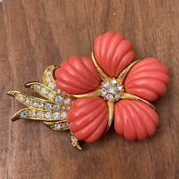 Vintage Brooch by Nolan Miller, Faux Coral Flower Design with Sparkling Crystals. C-clasp. Stamped. 2.5”l x 2”h.
